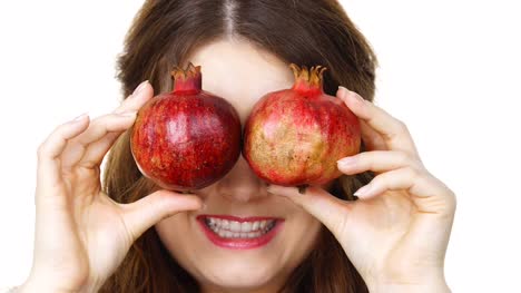 Cheerful-woman-holds-pomegranate-fruits,-isolated