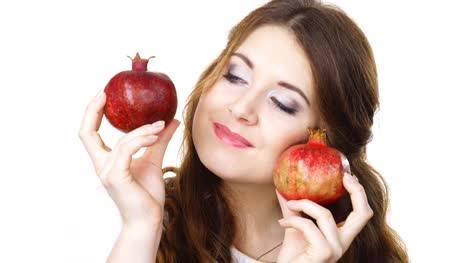 Cheerful-woman-holds-pomegranate-fruits