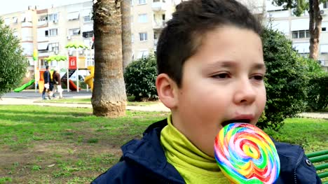 Portrait-of-preteen-child-eating-lollipop