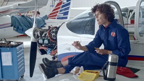 Weibliche-Flugzeug-Techniker-zu-Mittag-im-Hangar