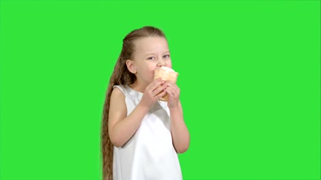 Kid-girl-eating-with-ice-cream-on-a-Green-Screen,-Chroma-Key