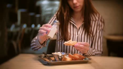 Woman-brunette-salt-sandwich-with-pate-in-cafe.