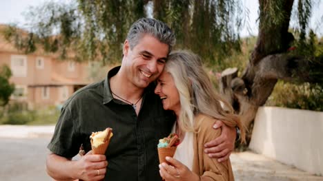 Feliz-pareja-multiétnica-comiendo-helado-en-primavera