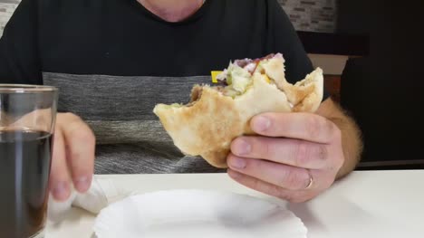 The-man-eats-kebabs-with-his-hands