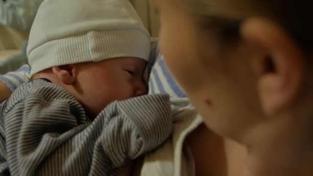 Mother-Breastfeeds-Newborn