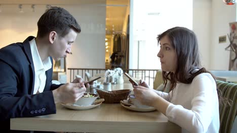 Business-meeting.-Young-man-and-woman-are-having-dinner