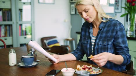 Beautiful-Blond-Woman-Reading-While-Eating-Breakfast