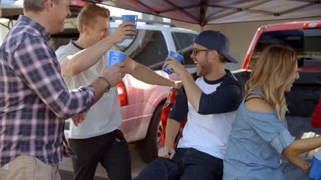 Slow-Motion-Shot-Of-Sports-Fans-Tailgating-In-Parking-Lot