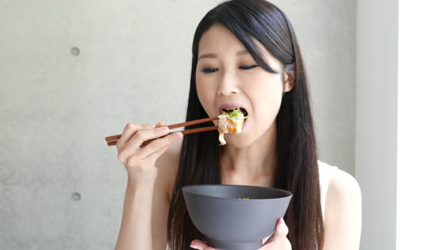 young-woman-eating-Katsudon