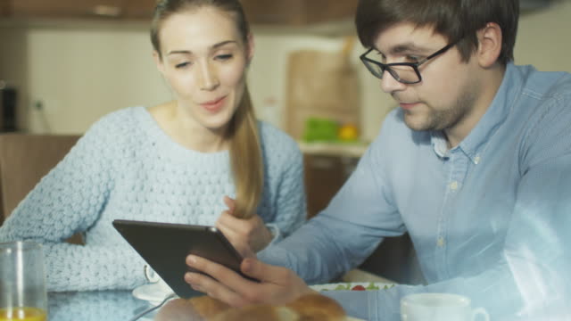 Couple-is-Using-Tablet-at-Home-in-Kitchen