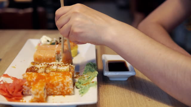 Freunde-Essen-Sushi-und-Dip-in-Soße