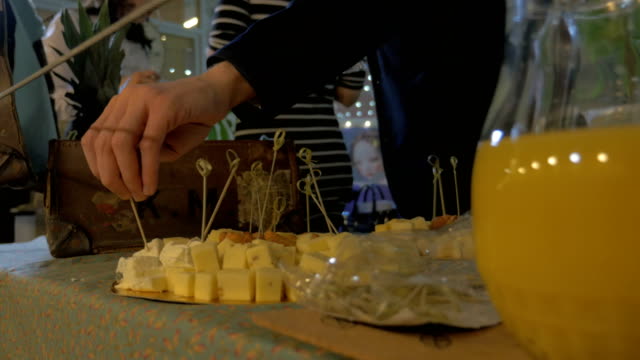 Man-taking-cheese-from-buffet-table