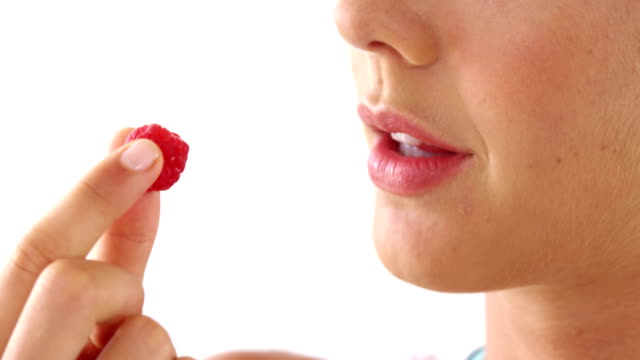 Close-up-of-woman-having-raspberries
