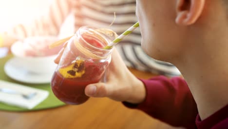 Close-up-Shot-of-a-Man-Drinking-Healthy-Smoothie-from-a-Stylish-Jar-Through-a-Straw.