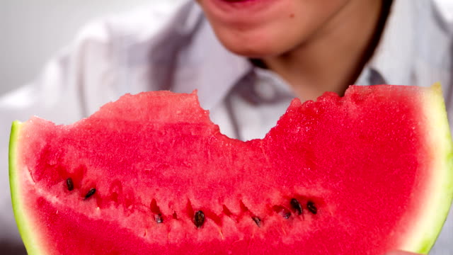 Boy-Bites-off-Slices-of-Watermelon