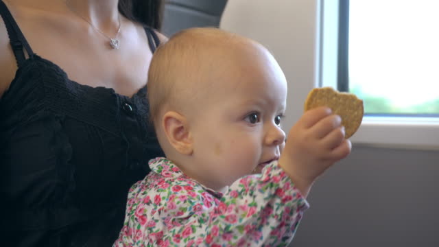 Un-bebé-comiendo-una-galleta-en-el-tren