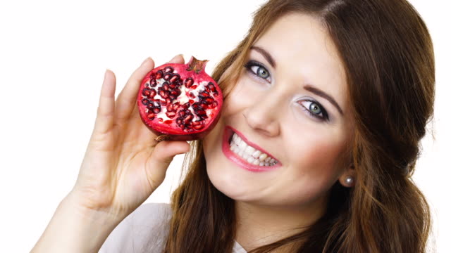 Woman-holds-half-of-pomegranate-fruit,-isolated
