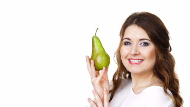 Charming-woman-holds-pear-fruit,-isolated