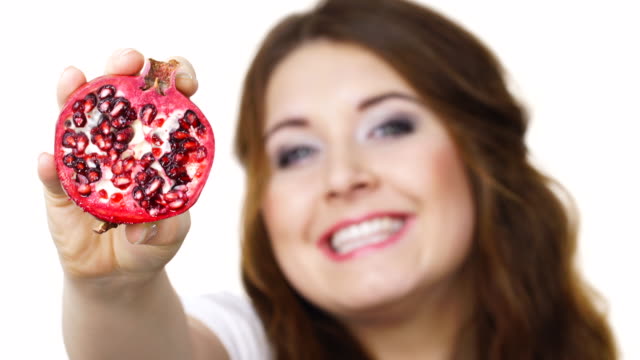 Woman-offering-pomegranate-fruit-on-white