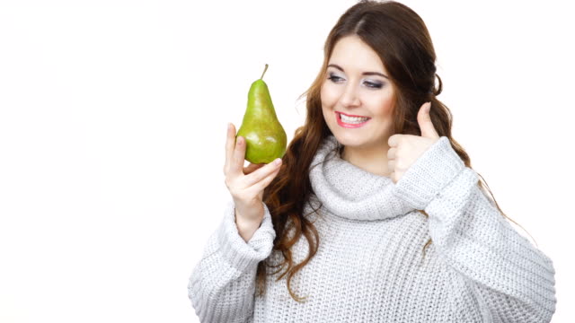 Woman-holds-pear-fruit-give-thumb-up-gesture,-isolated
