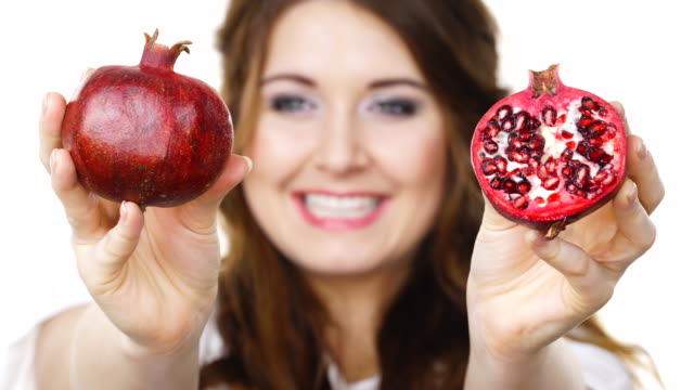Woman-offering-pomegranate-fruit-on-white