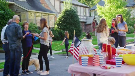Neighbours-talk,-eat-and-play-at-a-block-party
