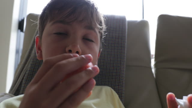 Child-eating-apple-indoors.-Young-boy-eats-healthy-fruit-in-4K