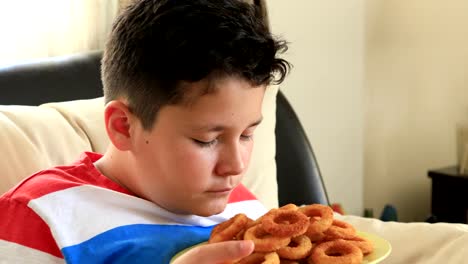 Young-boy-eating-onion-rings