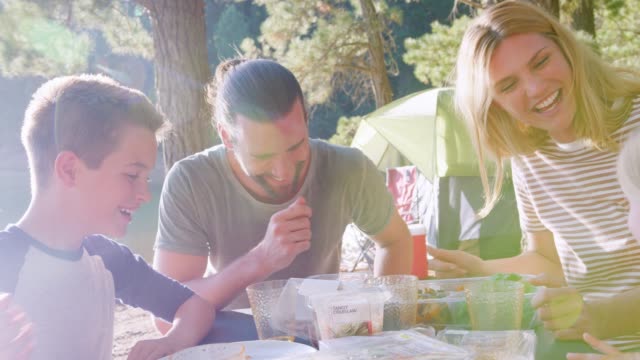 Familie-mit-Picknick,-wie-sie-von-See-auf-Abenteuer-im-Wald-Zelten