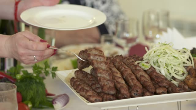 Armenian-lula-kebab-served-with-chopped-onion-on-decorative-platter