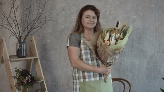 Smiling-woman-holding-edible-bouquet-arrangement