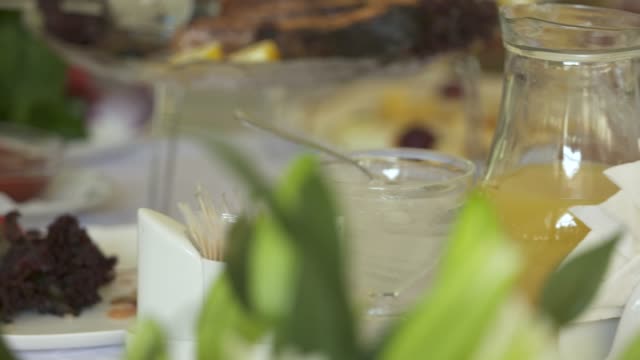 Close-up-of-dining-table-with-served-appetizers-and-beverages