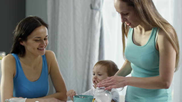 Female-Couple-with-Child-Having-Breakfast