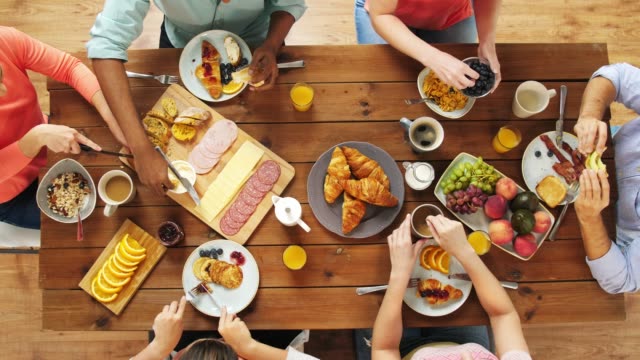 Grupo-de-personas-que-comen-en-la-mesa-con-la-comida