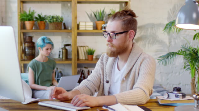 Hipster-Man-and-Woman-Working-on-Computers