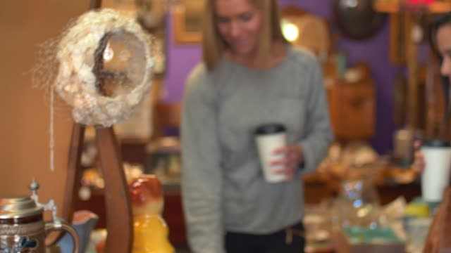 Two-friends-shopping-in-an-antiques-store