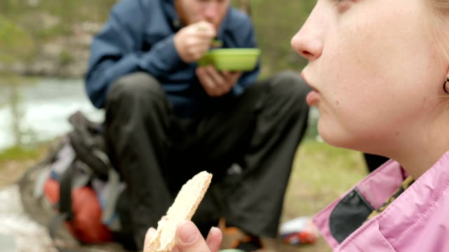 Girl-eats-bread-and-butter-outdoors