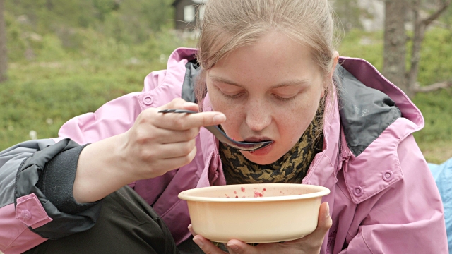 Girl-eats-soup-outdoors