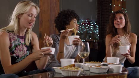 Three-female-friends-talking-and-eating-a-Chinese-take-away,-shot-on-R3D