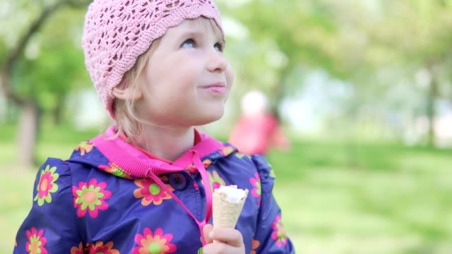 A-little-girl-eats-ice-cream-and-enjoys-herself-with-pleasure
