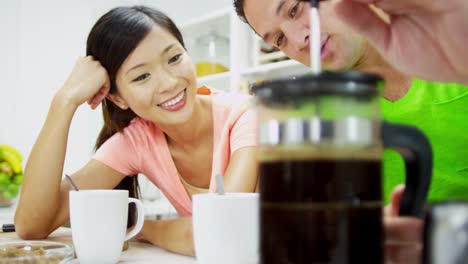 Young-Asian-Chinese-couple-preparing-fresh-breakfast-coffee