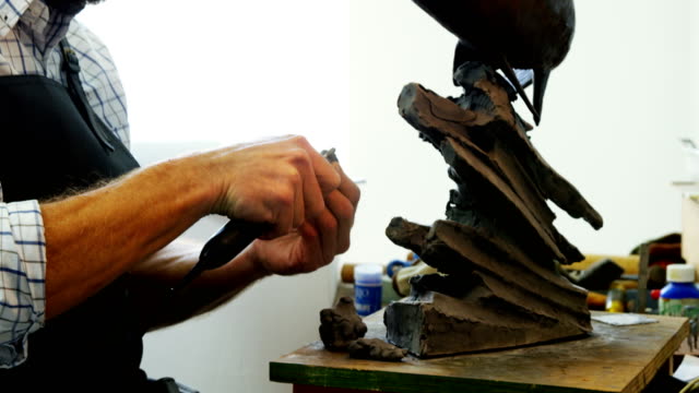 Craftsman-working-on-fish-sculpture-4k