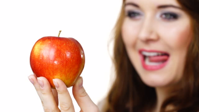 Woman-holds-red-apple,-focus-on-fruit