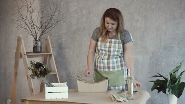 Woman-arranging-tools-to-create-edible-arrangement