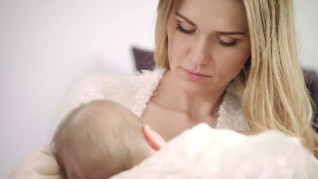 Young-mother-breast-feeding-new-born-child.-Enjoy-motherhood