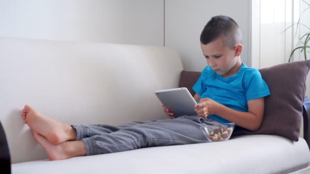 Excited-boy-reaches-goal-while-playing-on-tablet
