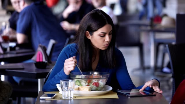 cute-young-Asian-woman-alone-at-the-restaurant,-eating-a-salad