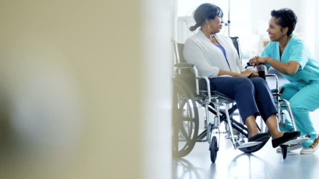 Portrait-of-ethnic-female-and-patient-in-wheelchair