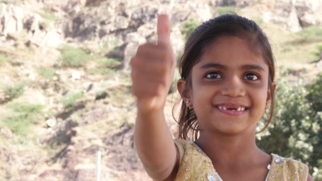 Thumbs-up-from-a-cute-little-Indian-girl-with-missing-teeth