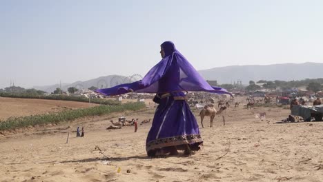 Rajasthani-Frau-tanzt-in-der-Wüste-Pushkar-während-Camel-fair